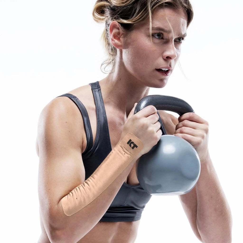 woman wearing kt tape to help wrist pain during a workout lifting weights
