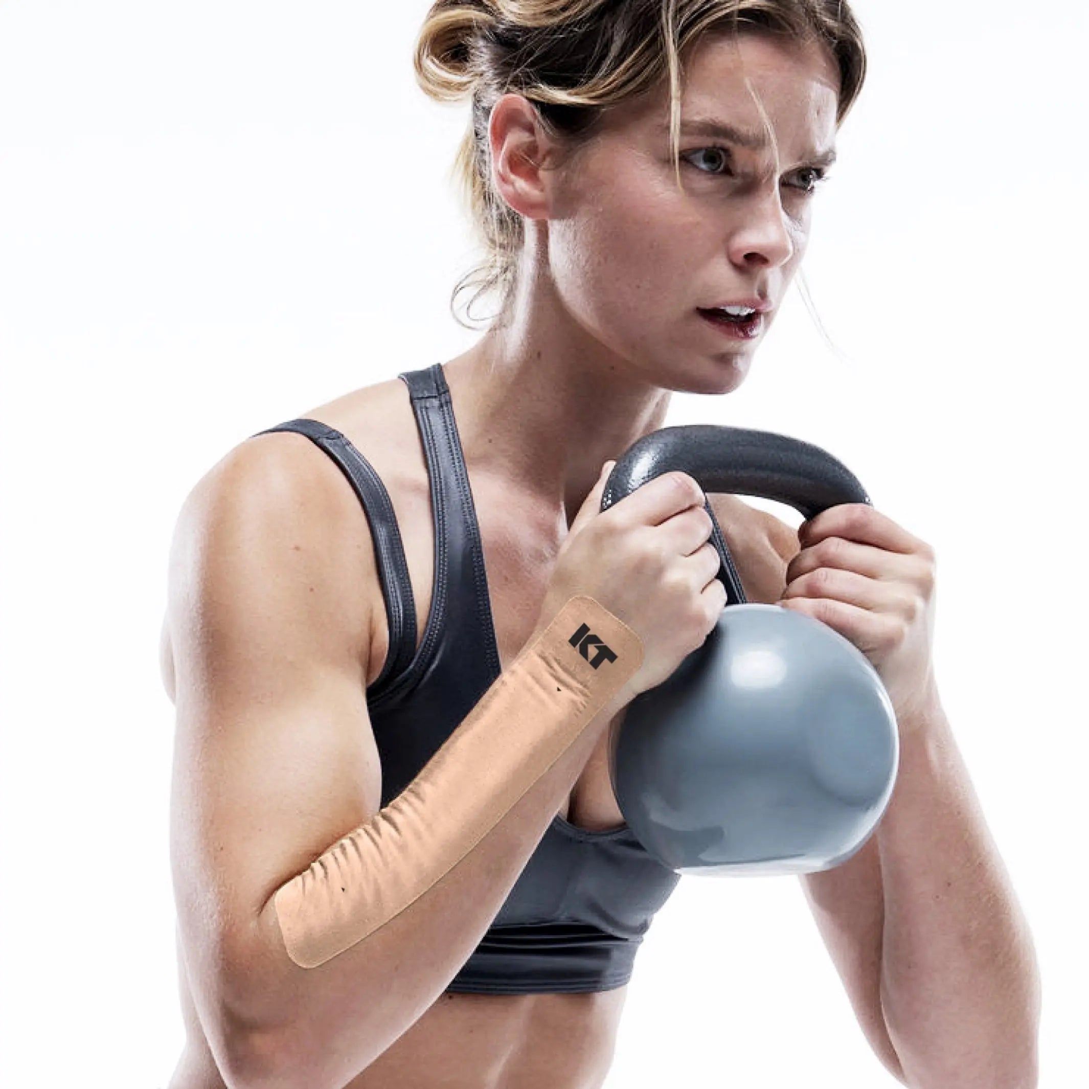 woman wearing kt tape to help wrist pain during a workout lifting weights